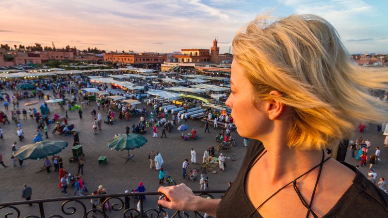 Solo female traveler walking through vibrant markets of Marrakech, capturing the spirit of Solo Female Travel in Morocco.
